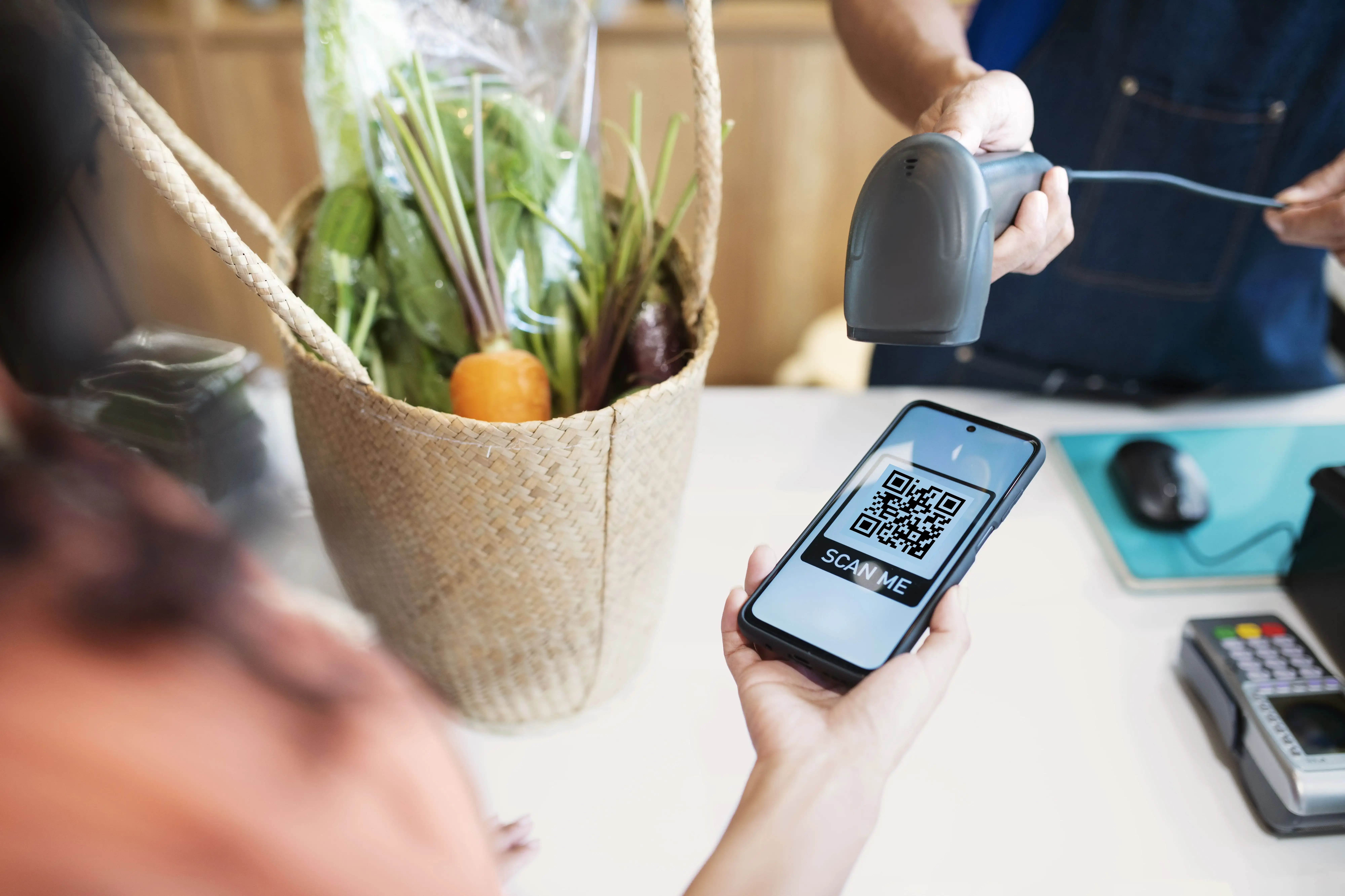 Local retailer helping customer scan QR code for enhanced service experience and loyalty program access