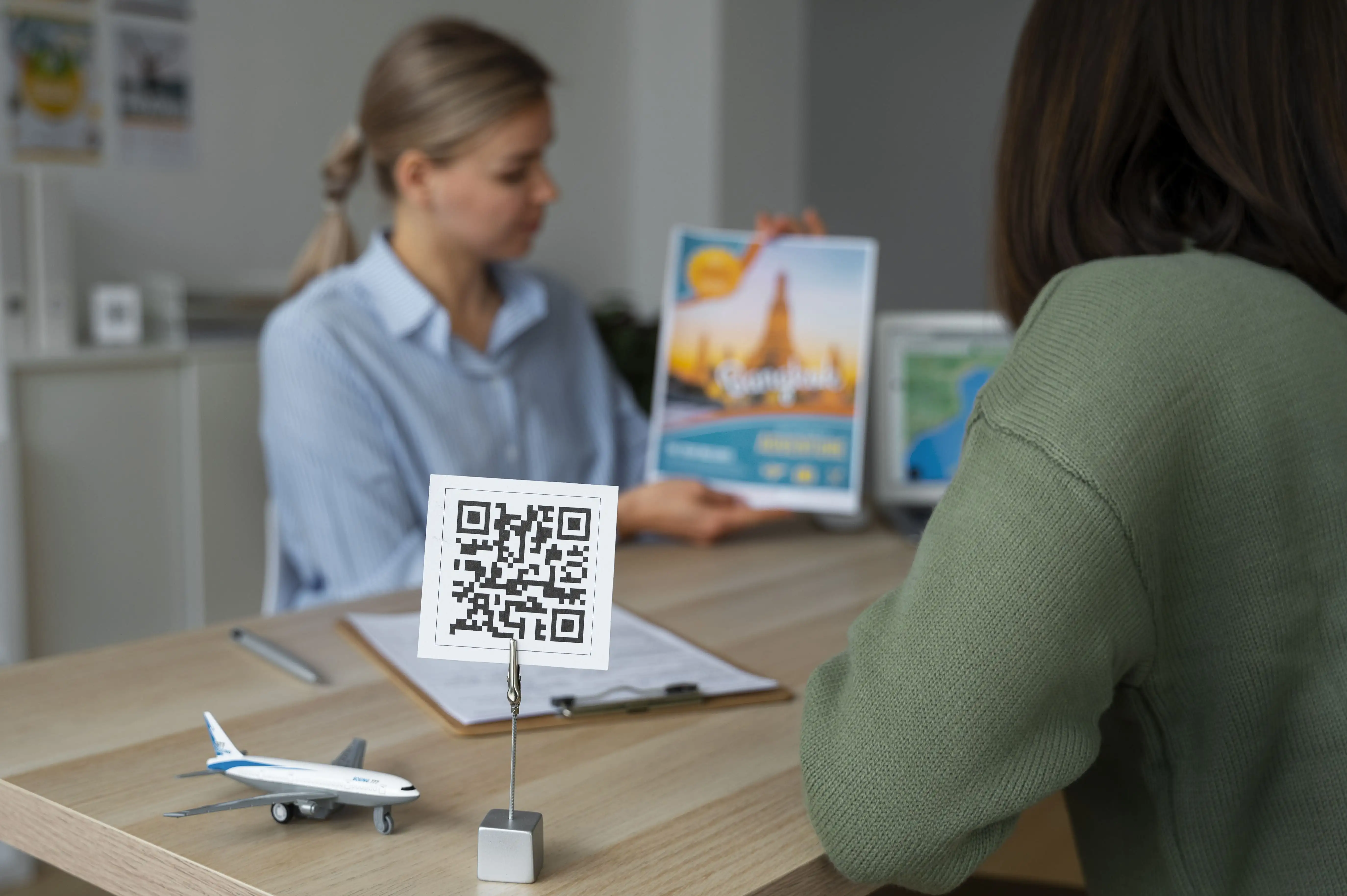 Side view of woman consultant presenting QR code for professional credentials and client communication access