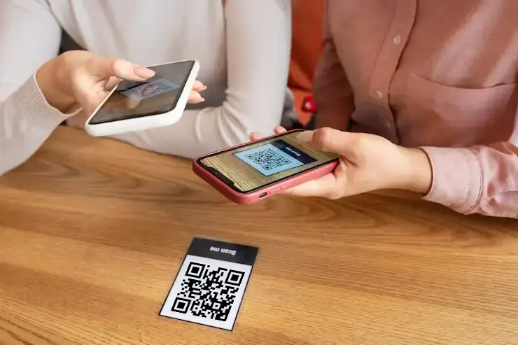 Hands using contactless QR code payment system for event merchandise and concession transactions