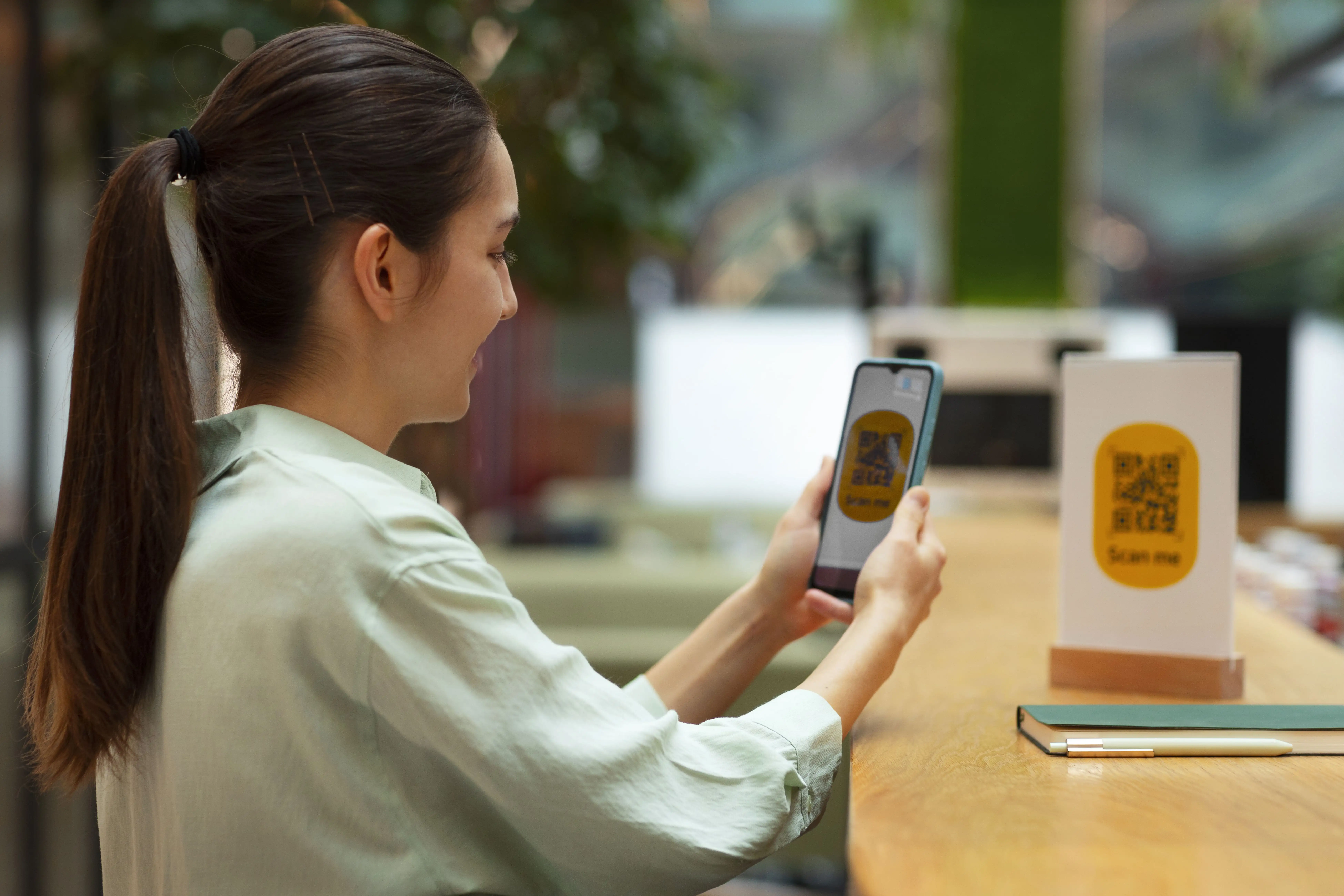 Woman engaging with interactive QR code system for event networking and attendee participation