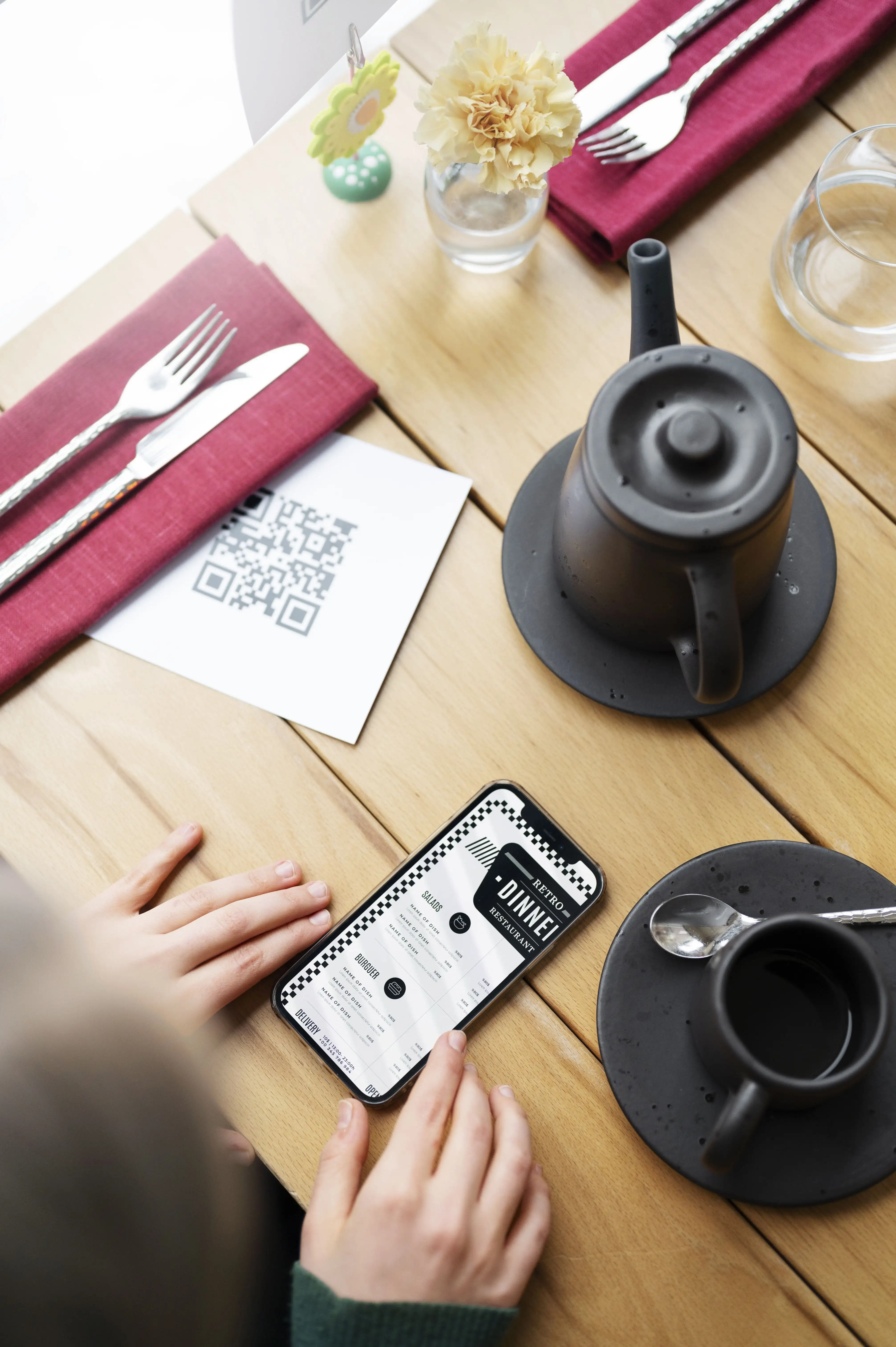 Overhead view of QR code menu placement on elegant restaurant table with coffee and dining utensils