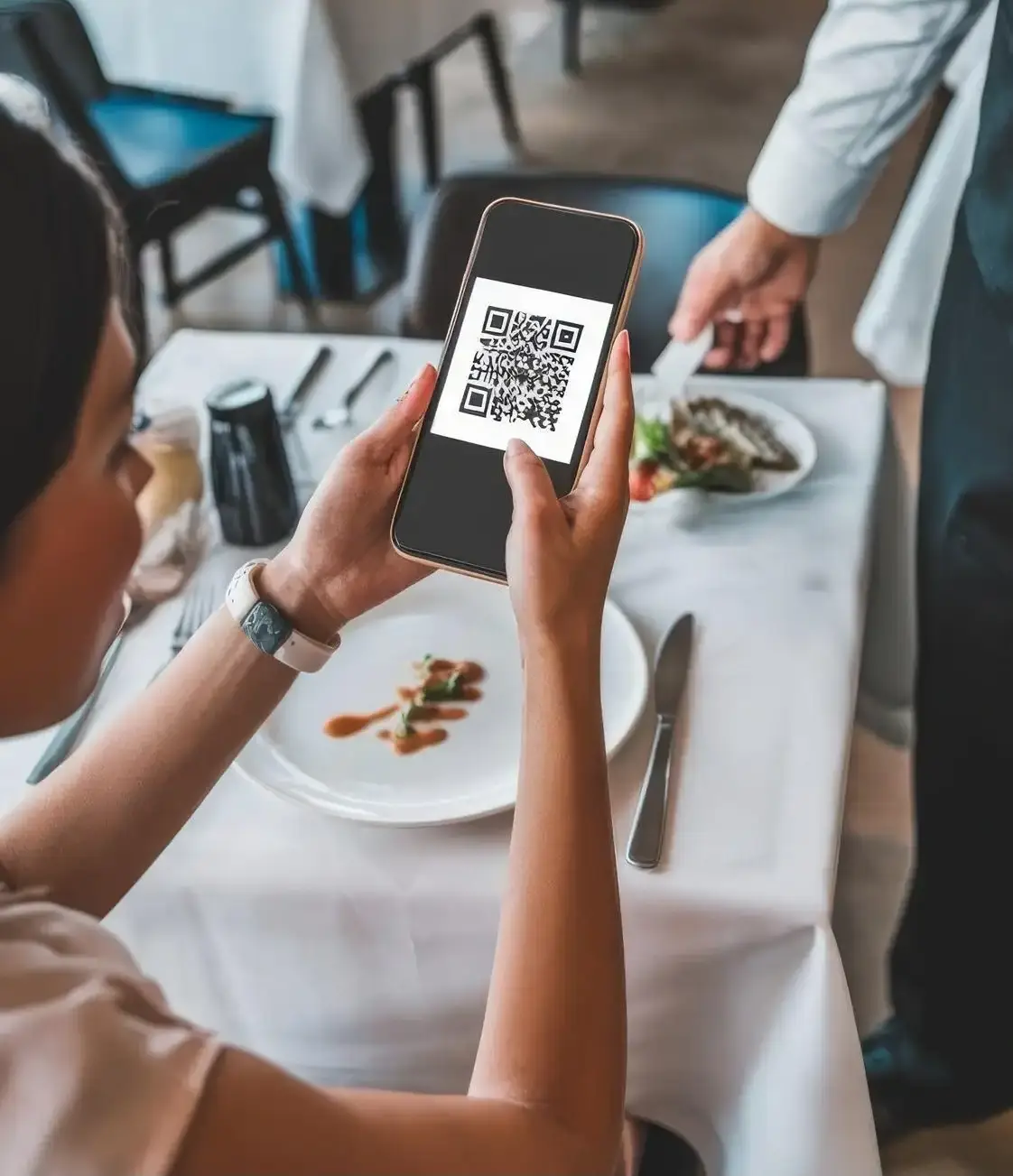 Alt Description: Customer scanning QR code menu with smartphone at fine dining restaurant table, demonstrating contactless digital menu ordering system for hospitality industry